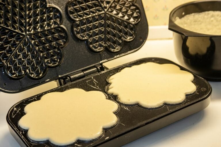 Making Norwegian waffles using a waffle iron.