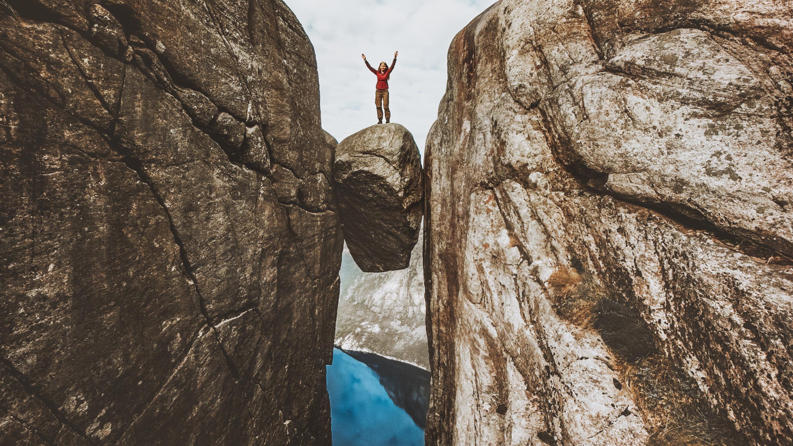 Hiker on the Kjerag boulder in Norway.