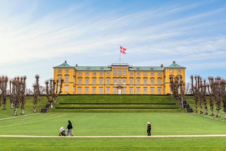 Locals walk through the grounds of Copenhagen's Frederiksberg Palace. Photo: Nick Brundle Photography / Shutterstock.com.