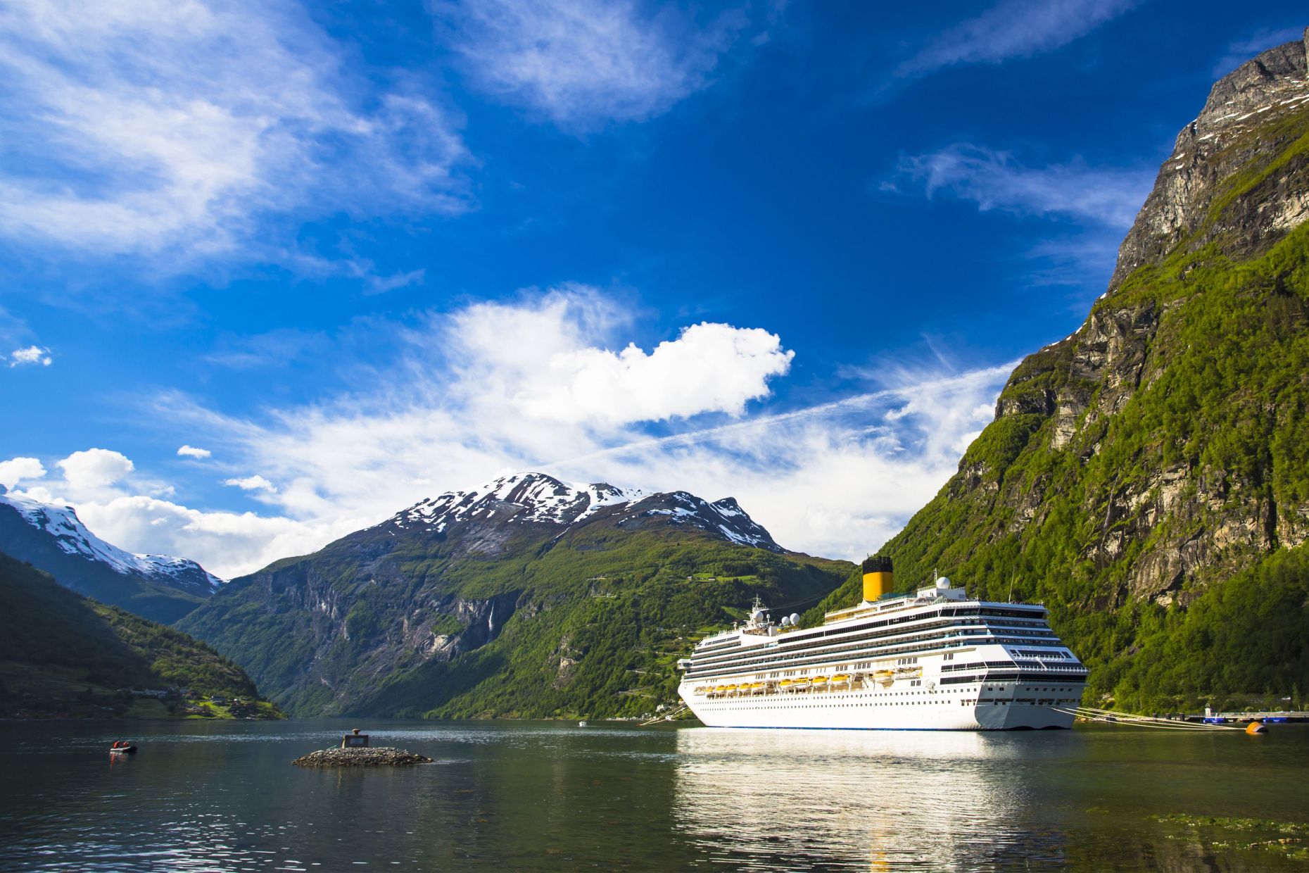 Norwegian fjords cruise ship at anchor in Geiranger, Norway.