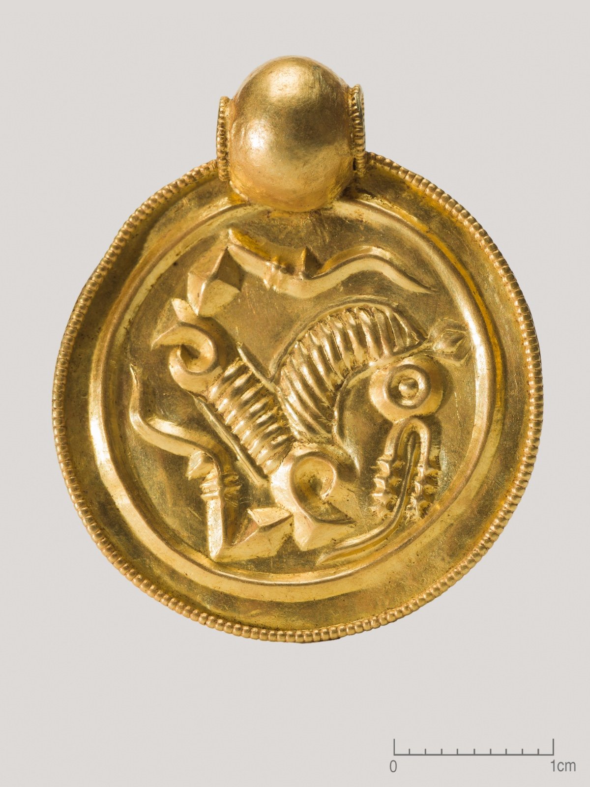 One of the nine gold pendants, or gold bracteates, that were found on Rennesøy. Photo: Museum of Archaeology.