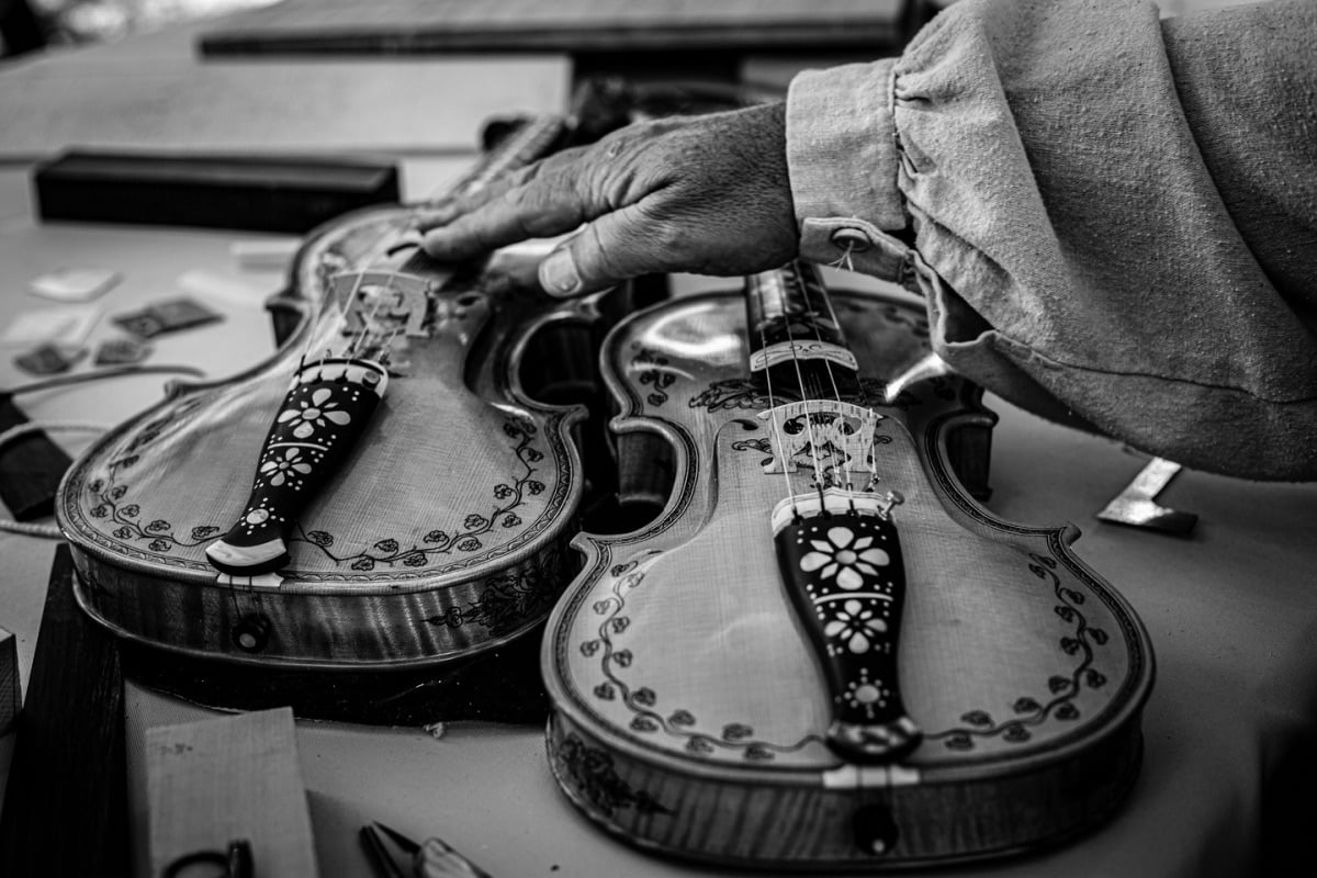 Hardanger fiddles and the hand of their maker.