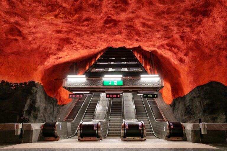 Escalators in the Rådhuset metro station Stockholm. The space is carved out of the rock and painted in black and red.