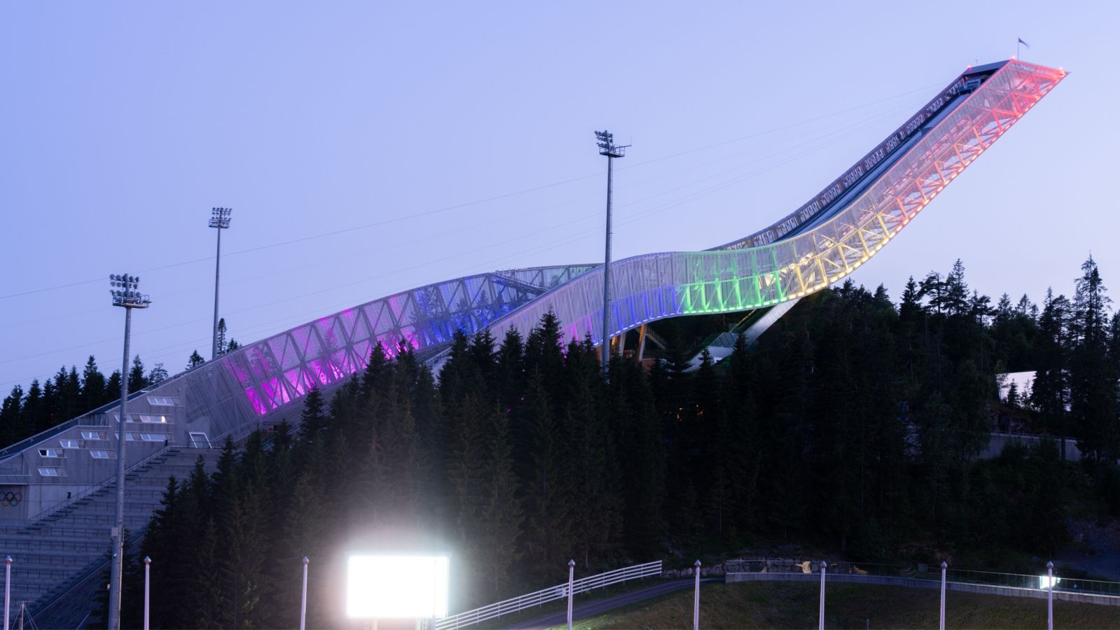 Oslo's Holmenkollen Ski Jump lit up in rainbow lights for Oslo Pride. Photo: Dreamnord / Shutterstock.com.