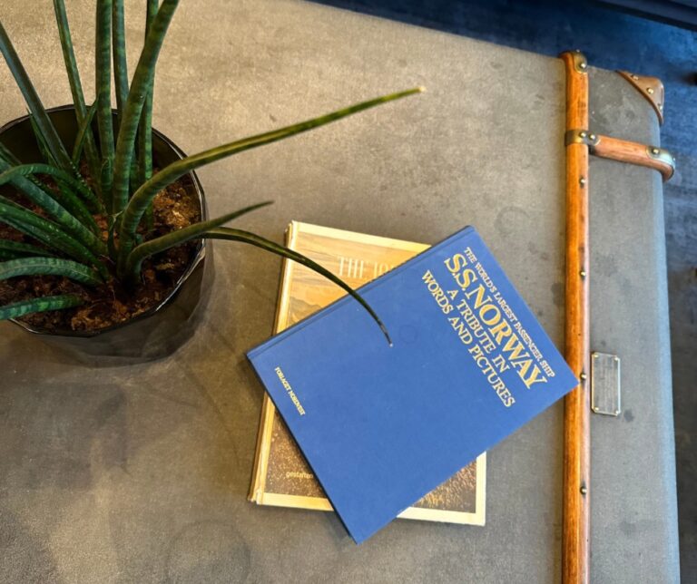 Baggage table and historic book in the foyer of Amerikalinjen. Photo: David Nikel.