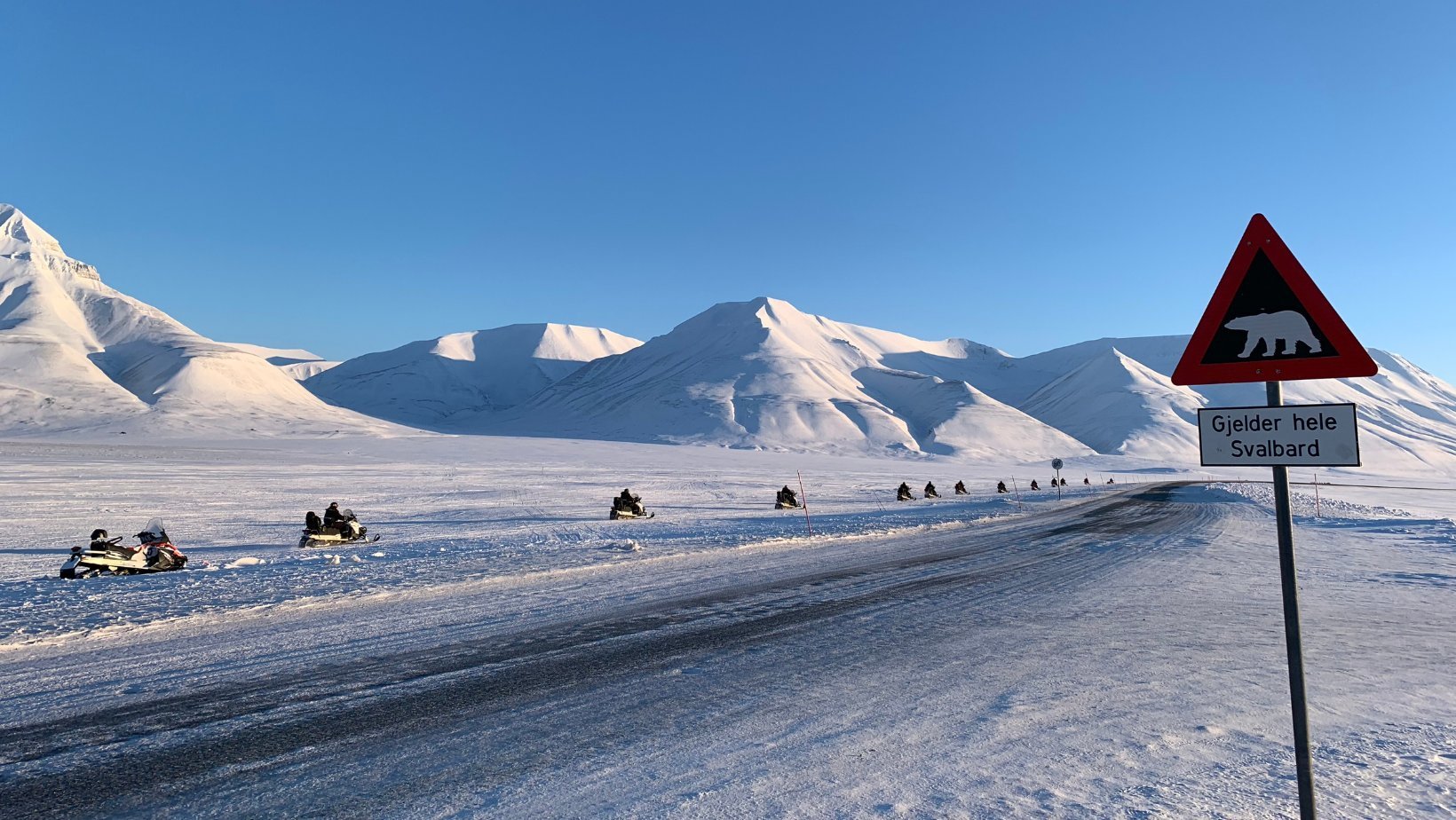 Snowscooter road in Svalbard winter. Photo: David Nikel.