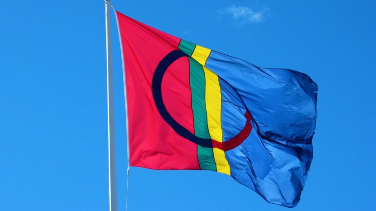 The Sami flag against a blue sky.