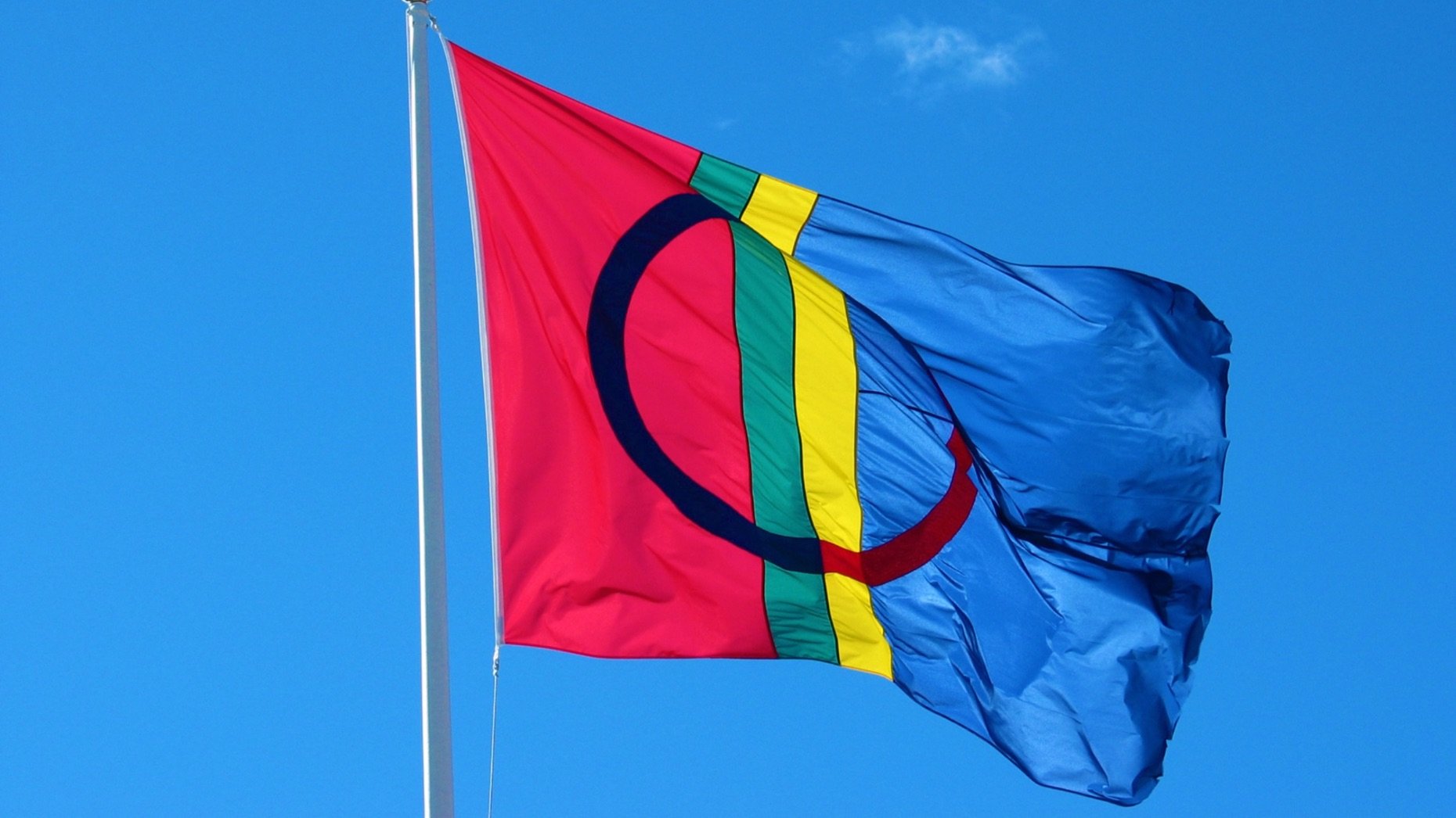 The Sami flag against a blue sky.