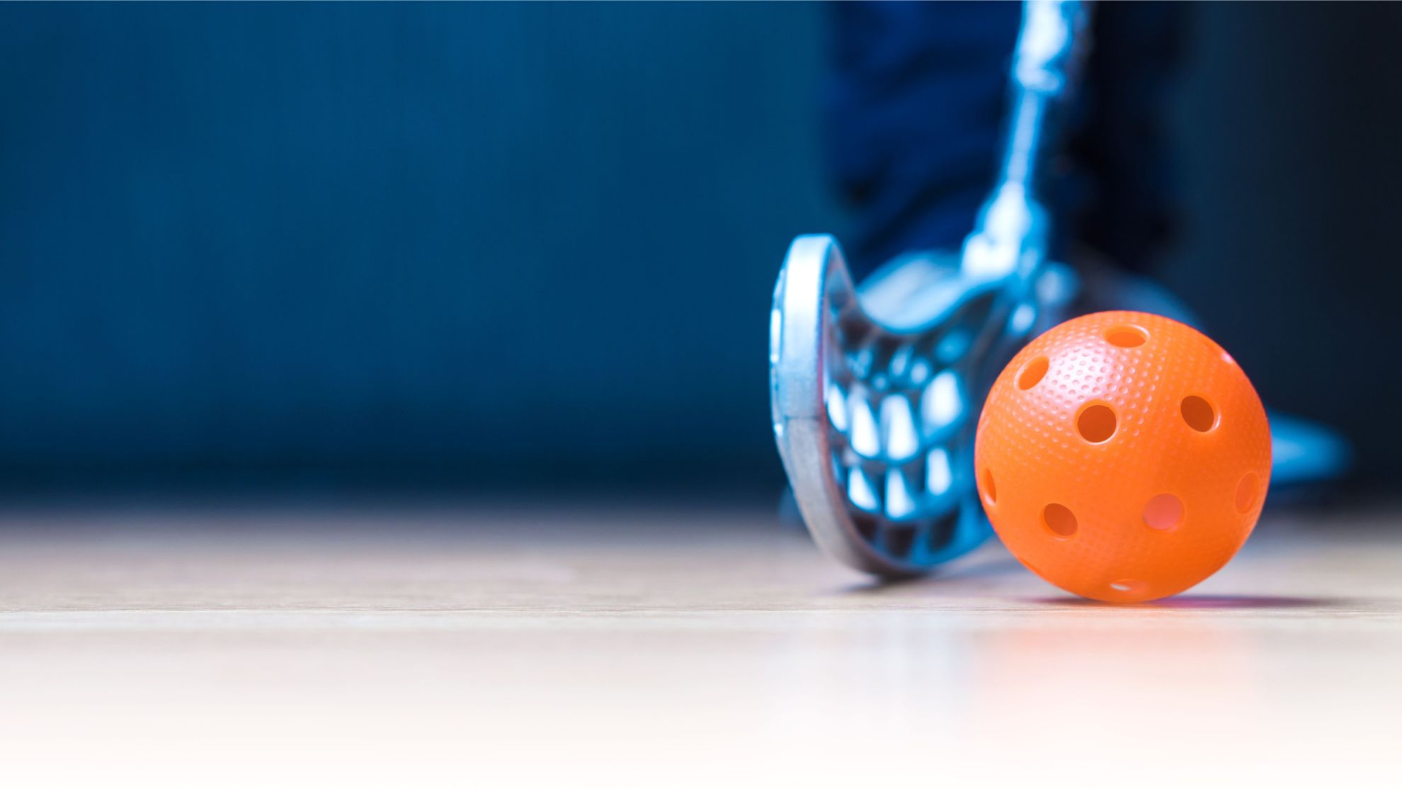 Floorball stick and ball image.