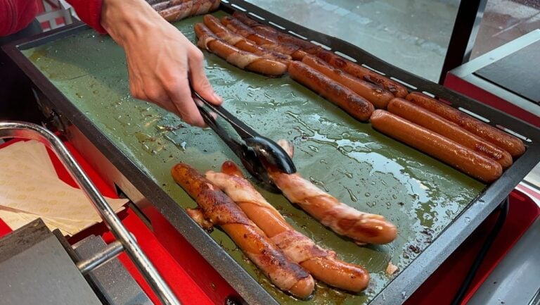 Different kinds of pølse being grilled on 17 May, Norway's Constitution Day. Photo: David Nikel.