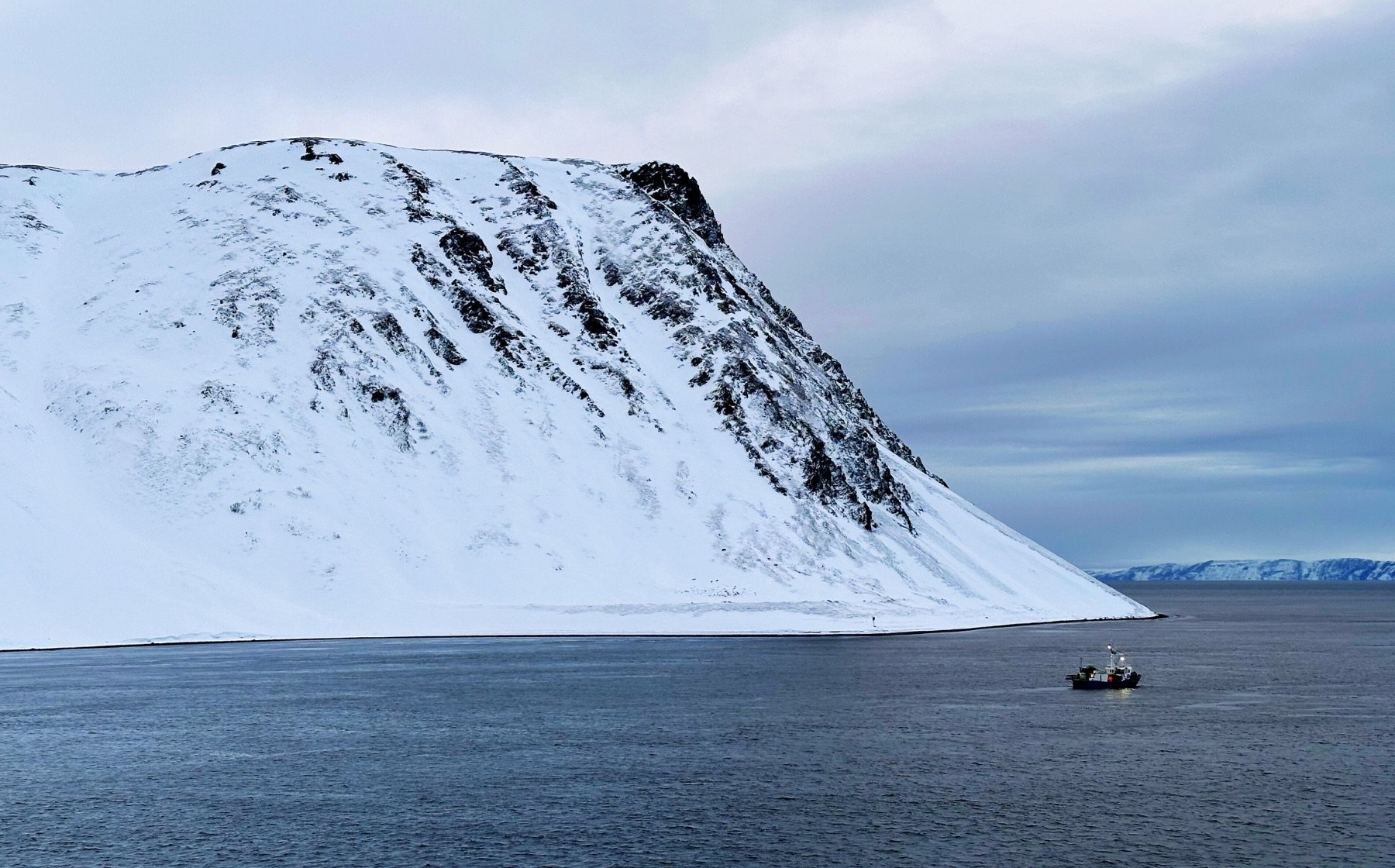 Sailing past a dramatic cliff on Magerøya island. Photo: David Nikel