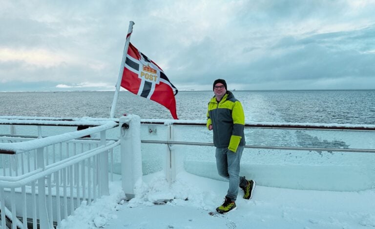 David on the Havila Polaris ferry with the flag of Norway. Photo: David Nikel.