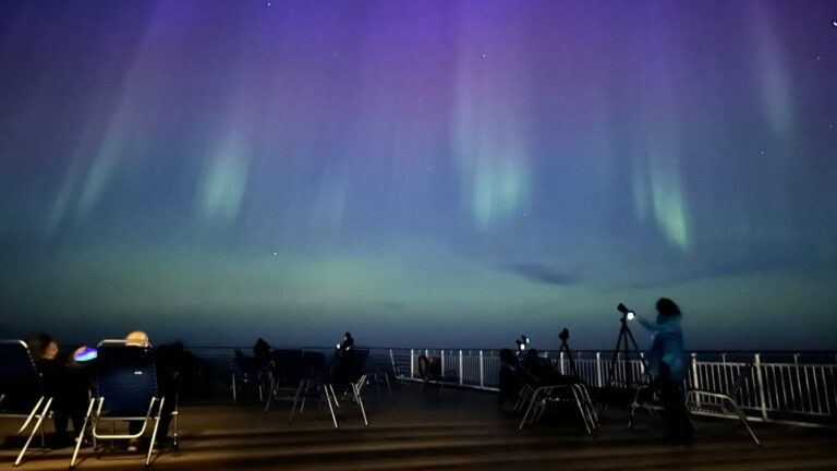 Passengers on deck nine of the Hurtigruten Trollfjord watching the northern lights. Photo: David Nikel.