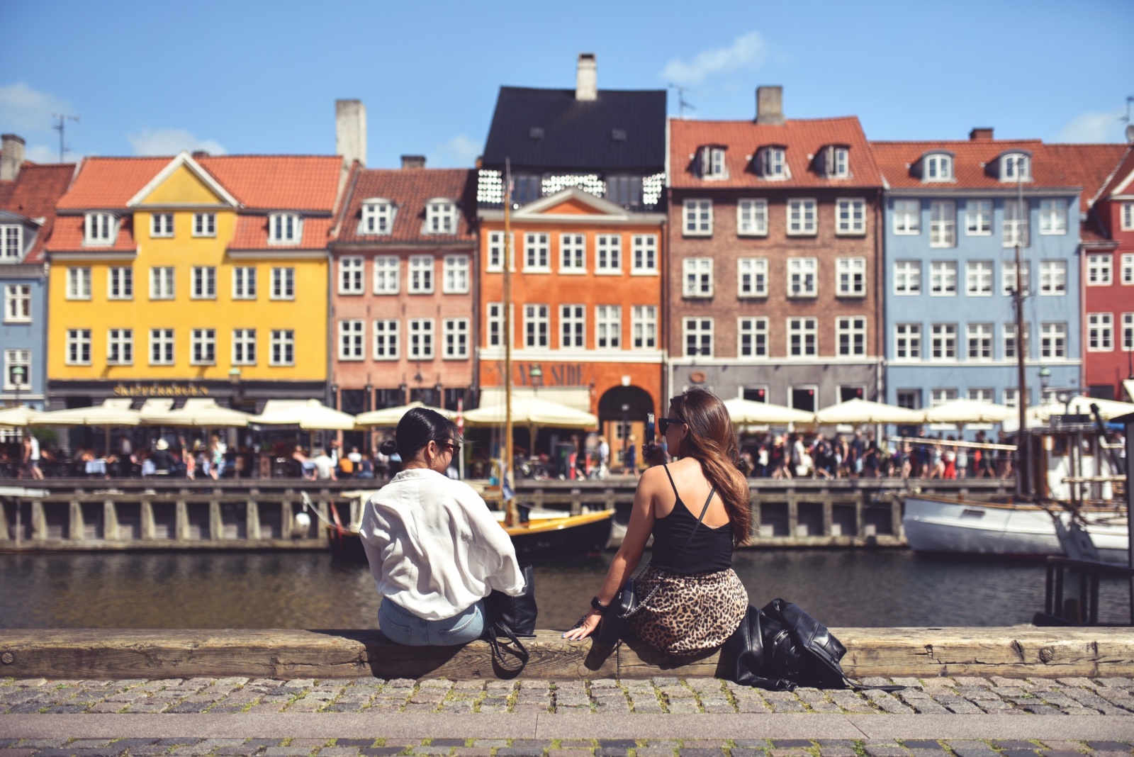 Two women chat in Copenhagen, Denmark. Photo: alexfan32 / Shutterstock.com.