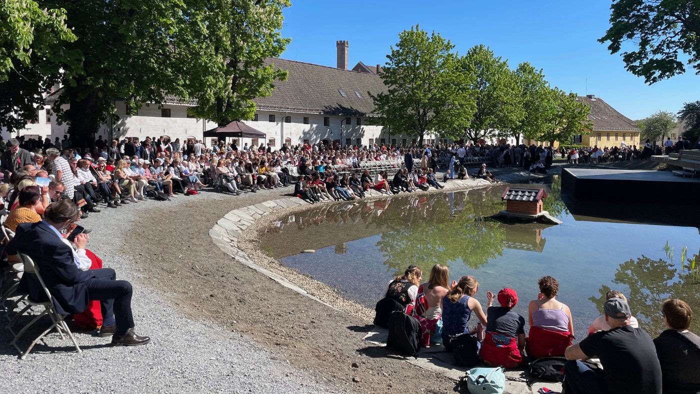 People gather at Akershus Fortress on 17 May in Oslo, Norway, for a Norwegian Constitution Day concert. Photo: David Nikel.