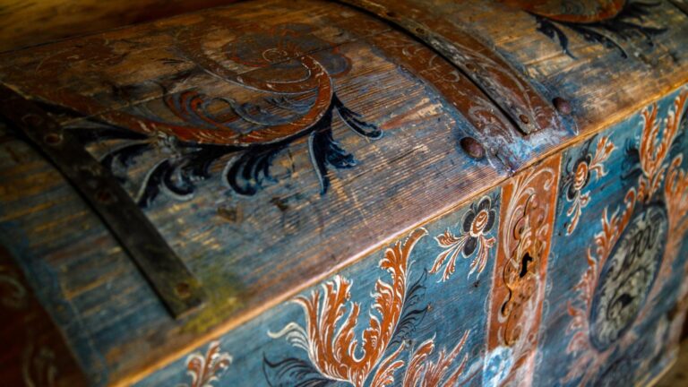 Trunk painted with rosemaling design.