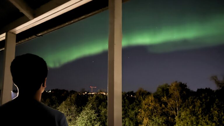 Man watching aurora borealis in Trondheim, Norway. Photo: David Nikel.