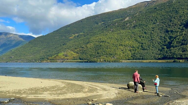 People on a beach in Flåm, Norway. Photo: David Nikel.