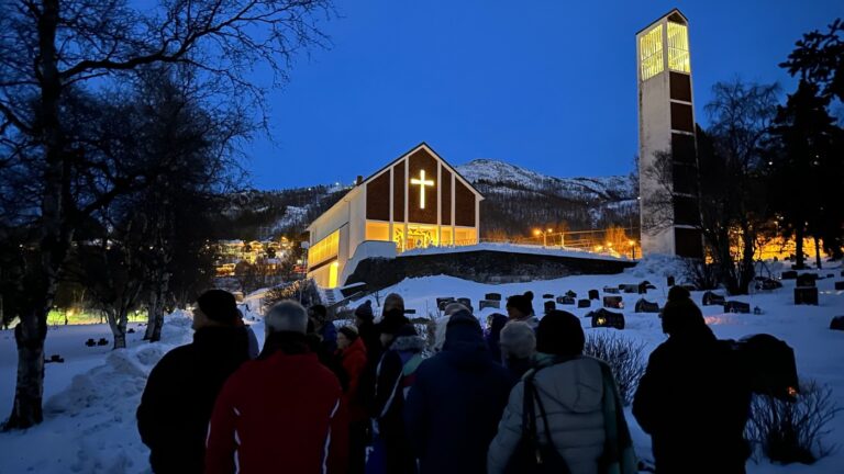 Visitors at Narvik new cemetery in twilight. Photo: David Nikel.