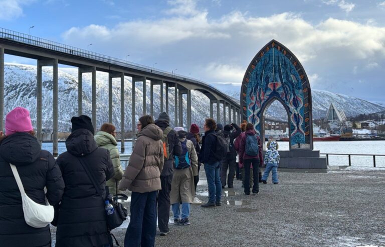 Line of tourists at Tromsø  monument 'Porten til Ishavet'. Photo: David Nikel.