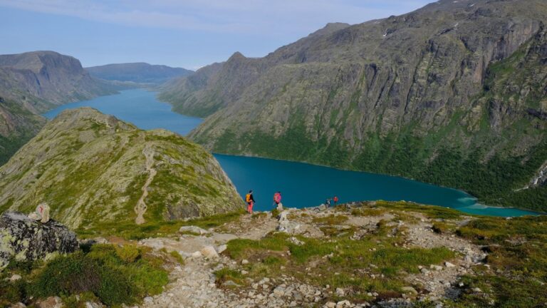 Hikers at Lake Gjende in Norway.