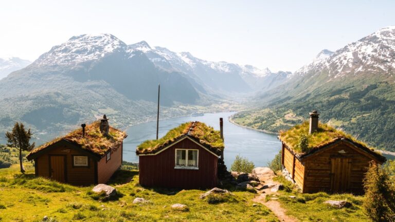 A scenic view of mountain pasture and traditional farm “seter” buildings at Rakssetra near Loen, Norway.