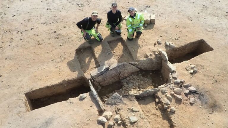 Archaeologists next to a prehistoric stone tomb discovered in Norway. Photo: Kulturhistorisk museum.